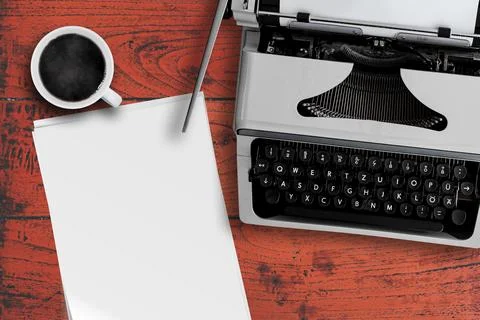 Directly above view of old typewriter, cup of steaming hot coffee and stack of 写真素材