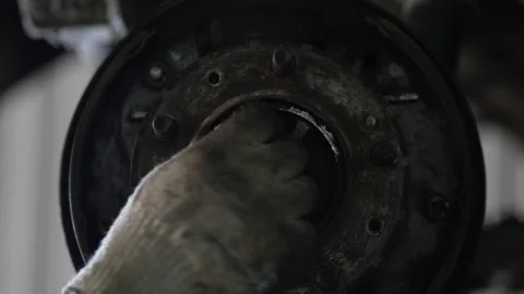 Directly facing dark metal wheel hub assembly center detail shot. Stock Footage 344230195