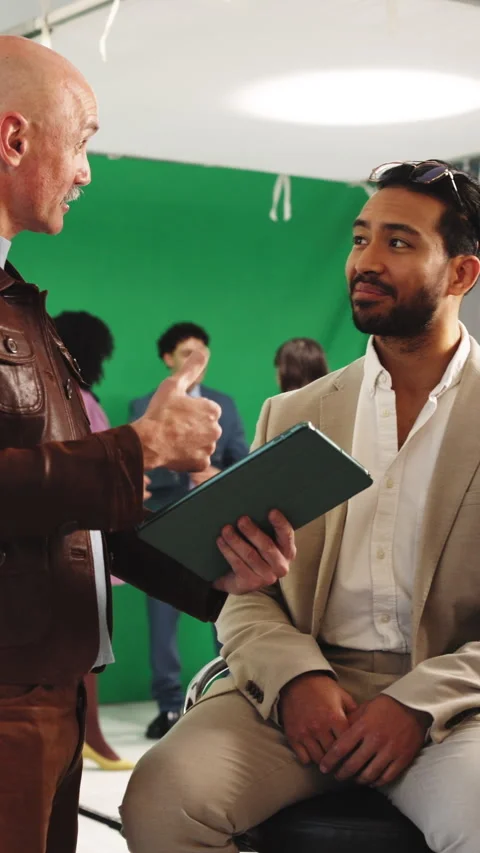 Director, actor and high five on film set with support, check tablet or makeup Stock Footage 340005433