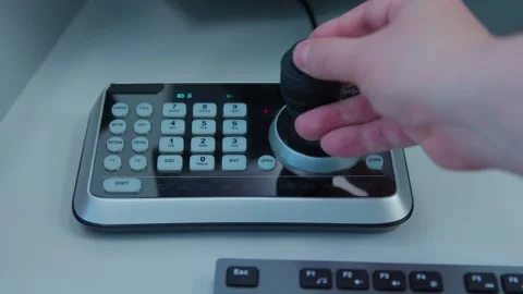 A director control camera angles a control panel during broadcast Stock Footage 277134694