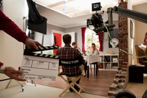 A director on a film set watching actors perform a scene Stock Photos