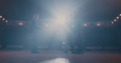 Director giving instructions to actors in spotlight Stock Footage 145234890