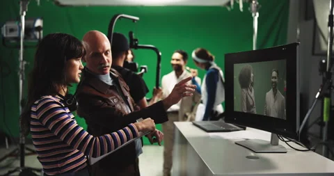 Director, green screen and assistant with videographer in production studio for Stock Footage 312681495