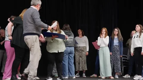 Director instructing actors on stage during rehearsals Stockbeeldmateriaal 334668899