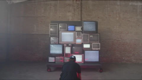 Director Positioning Lighting Near Stack Of TV's Stock Footage 270326092