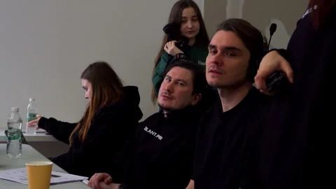 Director studies screen with crew exchanging sharp comments Stock Footage 308951648