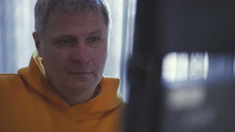 The director of the TV project, sitting in front of the monitor, wipes off the Stock Footage 105580298
