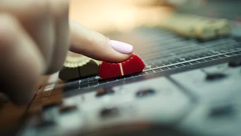 The director uses a mixing console Stock Footage 139384484