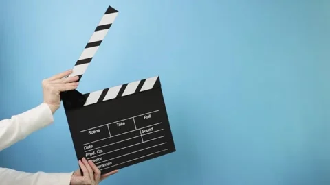 Director's hands using a clapperboard, indicating scene, take, and motion i.. Stock Footage 310373029
