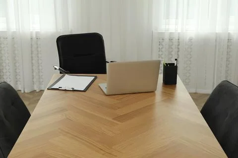 Director's office with large wooden table and comfortable armchairs. Interior Stock Photos