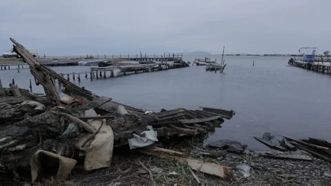 Dirt and garbage on the beach of a lagoon Stock Footage 108634661