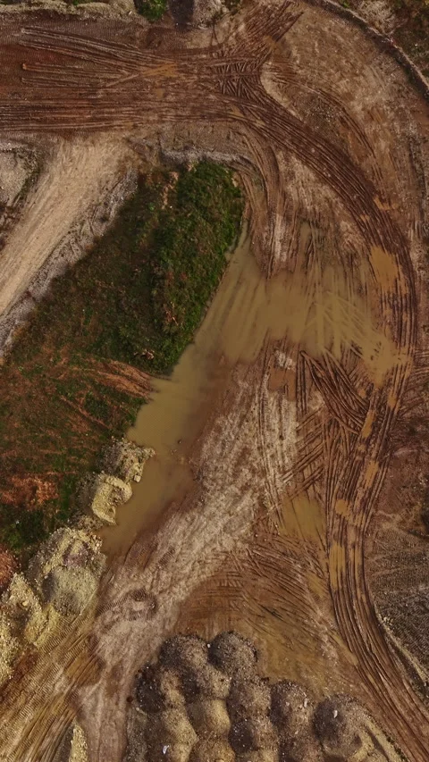 Dirt and mud blend in a construction site at dawn with machinery marks creating Stock Footage 331402947