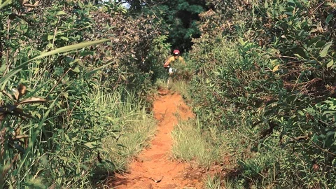 Dirt bike going down a small trail Stock Footage 86694161