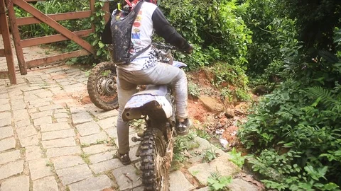 Dirt bike going down some scaring rocks Stock Footage 89721911