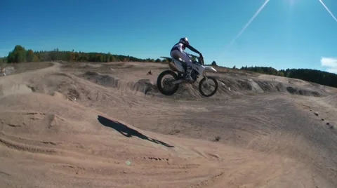 Dirt biker jumps down a big hill Stock Footage 45330895