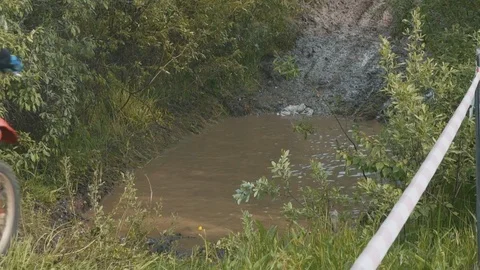 Dirt biker is passing a dirty puddle Stock Footage 82580689