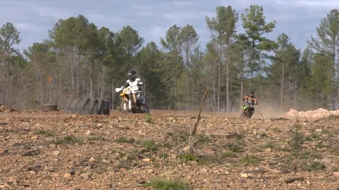 Dirt bikes race through path in the woods Video stock 85841495