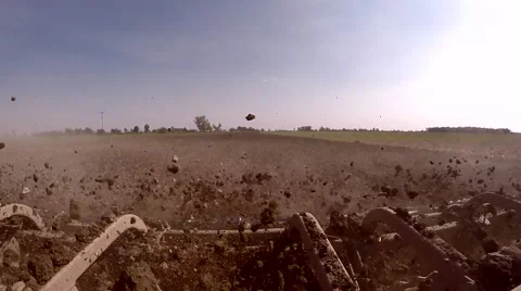 Dirt flies off a tilage tool plowing a field for GMO grain in Michigan USA Stock-Footage 64757143