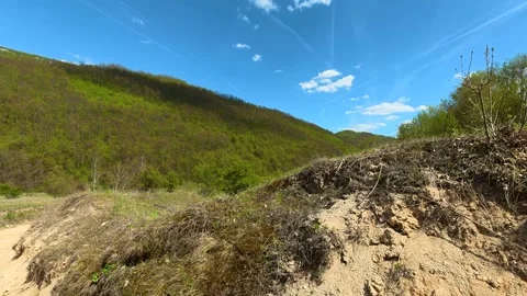 Dirt path winds through grassy hills. Balkan, Eastern Europe, POV Video stock 333589843