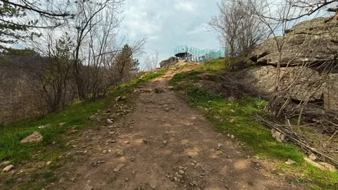 Dirt path winds uphill through sparse trees. Vucjanka Canyon, Serbia Stock Footage 332169730