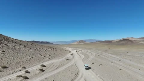 Dirt pathway traversing the vast, desolate high-elevation grassland valleys of Video stock 347488772