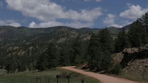 Dirt Road and Pine Trees Under Blue Sky with Clouds in Lake George CO Stock Footage 85214571