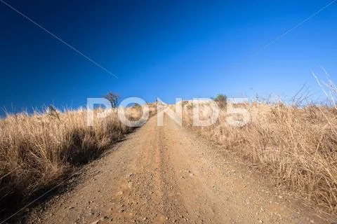 Dirt Road Blue Dry Horizon Stock Photos