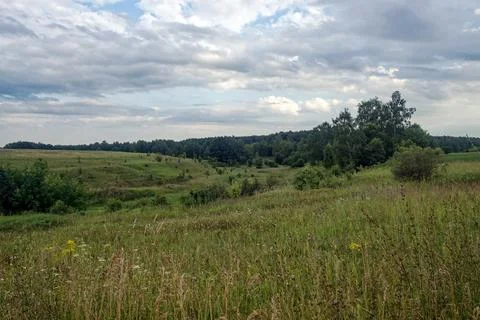 Dirt road in the countryside on a cloudy day Stock Photos