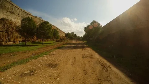 Dirt road in the deep moat of the ancient fortress of Famagusta with high walls Stock Footage 82108052