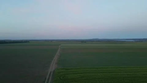 Dirt road going through the fields in the evening Stock Footage 256410533