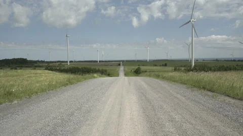 Dirt Road looking towards a Wind Farm Stockbeeldmateriaal 197569309
