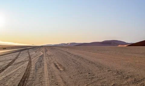 Dirt road in Namibia at evening time Stock Photos