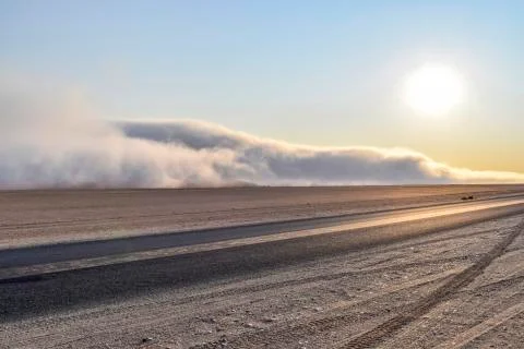 Dirt road in Namibia at evening time Stock Photos