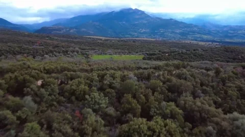 Dirt Road Through Valley with Clouds Over the Mountain Video stock 303564753