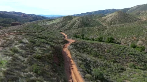 A dirt road winds through a desert Stock Footage 306417790