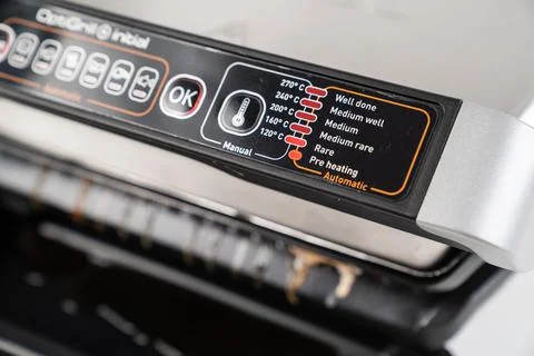 Dirty after cooking control panel. electric grill with closed lid. Stock Photos