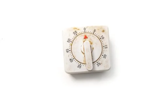 Dirty, aged square mechanical kitchen timer with a plastic knob, isolated o.. Stock Photos
