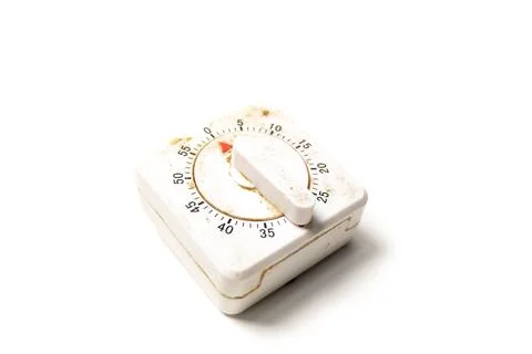 Dirty, aged square mechanical kitchen timer with a plastic knob, isolated o.. Stock Photos