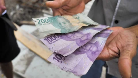 Dirty and crumpled old rupiah banknotes in hand. slow motion shot. Stock Footage 239723101