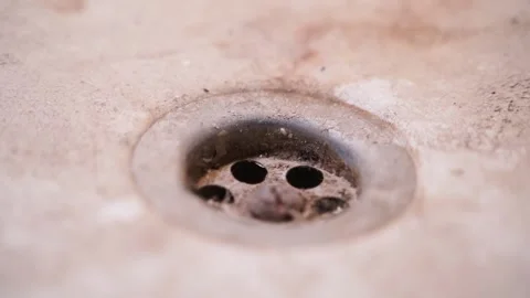 Dirty bathroom drain close-up. Plaque and dirt on the drain, smooth sliding of Stock Footage 235680592