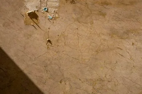 Dirty brown marble background texture with a torn out sign Stock Photos