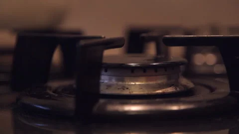 In a dirty budget kitchen with a dim light on the gas stove Stock Footage 106328259