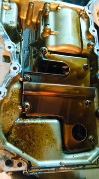 Dirty car engine sump. Stock Photos