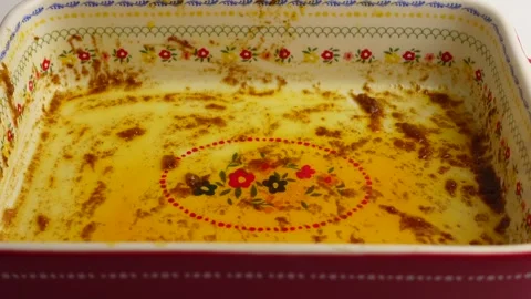 Dirty ceramic baking dish covered in grease and leftover food residue after.. Stock Footage 332269176