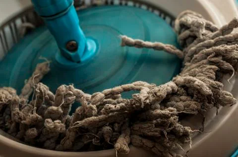 Dirty cleaning mop in a plastic container Stock Photos