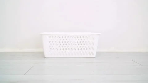 Dirty clothes falling into the laundry basket Stock Footage 130182916