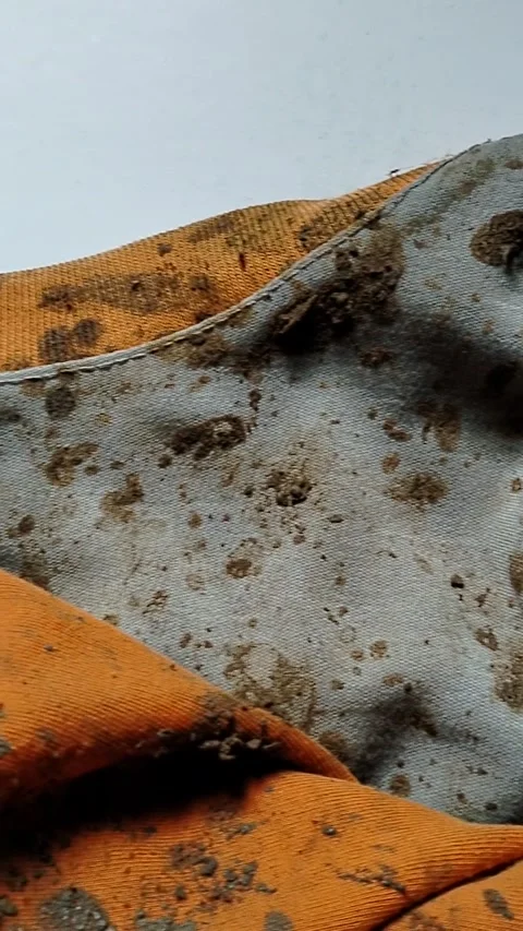 Dirty clothes with mud stains, messy fabric texture showing outdoor activity. Stock Footage 332320541