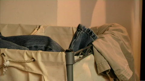 Dirty Clothes Thrown in Hamper Stock Footage 529968