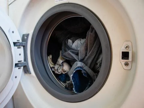 Dirty clothes in the washing machine ready to be washed Stock Photos