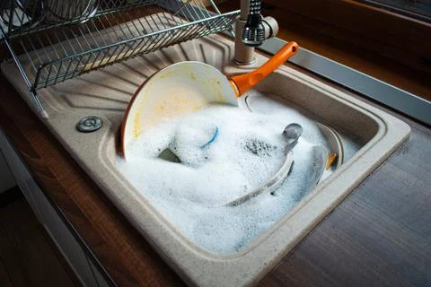 Dirty dishes in sink. Stock Photos